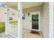 Inviting front porch with white railing and decorative welcome mat at 217 Almora Loop, Mooresville, NC 28115