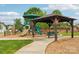 Community playground with slides, climbing structures, and shaded benches at 217 Almora Loop, Mooresville, NC 28115