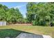 Backyard featuring a wooden deck, lush green grass, and tall trees in a peaceful, private setting at 2751 Bramble Ridge Ct, Charlotte, NC 28215