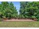 A generously sized wooden deck in a lush backyard setting with plenty of surrounding trees at 2751 Bramble Ridge Ct, Charlotte, NC 28215