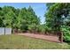 Wooden backyard deck surrounded by mature trees and shrubbery, creating a private outdoor space at 2751 Bramble Ridge Ct, Charlotte, NC 28215