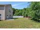 Wide shot of the backyard, showcasing the deck, white fence, and mature trees, perfect for outdoor activities at 2751 Bramble Ridge Ct, Charlotte, NC 28215