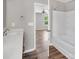 Bright bathroom boasts a tub and shower combination, alongside a modern single sink vanity at 2751 Bramble Ridge Ct, Charlotte, NC 28215