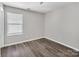 A bedroom with a window and wood-look vinyl flooring at 2751 Bramble Ridge Ct, Charlotte, NC 28215