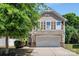 Charming two-story home with a two-car garage, stone accents, and mature landscaping at 2751 Bramble Ridge Ct, Charlotte, NC 28215