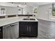 Kitchen with wood floors, stainless steel dishwasher, dark cabinets, and breakfast bar overlooking living area at 2751 Bramble Ridge Ct, Charlotte, NC 28215