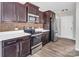 Kitchen with stainless steel appliances, dark cabinets, granite countertops, and wood flooring at 2751 Bramble Ridge Ct, Charlotte, NC 28215