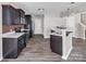 Spacious kitchen with dark cabinets, stainless steel appliances, and breakfast bar with sink at 2751 Bramble Ridge Ct, Charlotte, NC 28215
