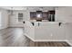 Modern kitchen featuring a breakfast bar, stainless steel appliances, dark cabinets, and wood flooring at 2751 Bramble Ridge Ct, Charlotte, NC 28215