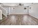 Large living room with hardwood floors, a ceiling fan, and natural light at 2751 Bramble Ridge Ct, Charlotte, NC 28215