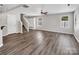 Open living room with stairs, hardwood flooring, and large windows at 2751 Bramble Ridge Ct, Charlotte, NC 28215