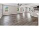 Spacious living area showcasing wood floors, recessed lighting, and abundant natural light from multiple windows at 2751 Bramble Ridge Ct, Charlotte, NC 28215
