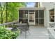 Charming back porch with a dining table and chairs, with views of the screened porch at 3134 Old Chapel Ln, Charlotte, NC 28210