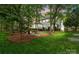 Beautiful backyard featuring a fire pit and mature trees, ideal for relaxing and enjoying the outdoors at 3134 Old Chapel Ln, Charlotte, NC 28210