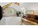 Bright bonus room with a leather sofa, desk area, and climbing wall in the background at 3134 Old Chapel Ln, Charlotte, NC 28210