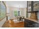 Charming dining area featuring a white table, hardwood floors, and modern light fixtures at 3134 Old Chapel Ln, Charlotte, NC 28210
