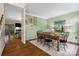 Inviting dining room features hardwood floors, green walls, and a table set for a delightful meal at 3134 Old Chapel Ln, Charlotte, NC 28210