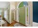 Bright foyer featuring a green front door, hardwood floors, and a decorative mirror at 3134 Old Chapel Ln, Charlotte, NC 28210