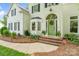 Inviting front entrance with a green door, brick steps, and beautiful landscaping at 3134 Old Chapel Ln, Charlotte, NC 28210