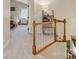 Well-lit hallway with carpeted floors and wooden railings, leading to a bedroom and other living spaces at 3134 Old Chapel Ln, Charlotte, NC 28210