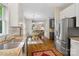 Bright kitchen showcases granite countertops, stainless steel appliances, and hardwood floors leading to an open dining area at 3134 Old Chapel Ln, Charlotte, NC 28210