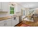 Charming kitchen featuring granite countertops, white cabinets, and stainless steel appliances, complemented by hardwood floors at 3134 Old Chapel Ln, Charlotte, NC 28210