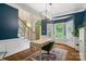Well-lit office space featuring blue accent walls, a modern desk, and large windows with plantation shutters at 3134 Old Chapel Ln, Charlotte, NC 28210