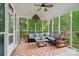 Relaxing screened porch featuring comfortable seating, an outdoor rug, and serene backyard views at 3134 Old Chapel Ln, Charlotte, NC 28210
