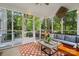 Enclosed porch with an area rug, comfortable furniture, string lights, and a view of the outdoors at 3134 Old Chapel Ln, Charlotte, NC 28210