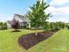 Expansive backyard with mature landscaping, privacy fence, screened porch, and inviting patio area for outdoor enjoyment at 3333 Oliver Stanley Trl, Lancaster, SC 29720