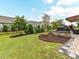 Serene backyard with a grill station, brick patio, manicured lawn, and mature landscaping with privacy fencing at 3333 Oliver Stanley Trl, Lancaster, SC 29720