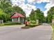 Community entrance with a gatehouse, stone pillars, landscaped grounds, and brick-paved road at 3333 Oliver Stanley Trl, Lancaster, SC 29720