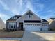 Charming single-Gathering home featuring a two-car garage, stone accents, and manicured front yard at 3333 Oliver Stanley Trl, Lancaster, SC 29720