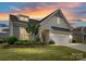 Charming home with a two-car garage, landscaping, and a colorful sunset at 3333 Oliver Stanley Trl, Lancaster, SC 29720