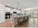 Bright, open kitchen features white cabinets, granite countertops, and a large island with seating at 3333 Oliver Stanley Trl, Lancaster, SC 29720