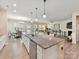 A bright kitchen features an expansive island with seating, stainless steel appliances at 3333 Oliver Stanley Trl, Lancaster, SC 29720