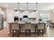 A kitchen features white cabinets, granite countertops, and a large island with seating at 3333 Oliver Stanley Trl, Lancaster, SC 29720