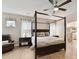 Spacious main bedroom with a four-poster bed, ceiling fan, and ensuite bathroom at 3333 Oliver Stanley Trl, Lancaster, SC 29720