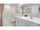 Stylish bathroom featuring double sinks, tub with shower, and decorative art at 414 Janie Nw Cir, Newton, NC 28658