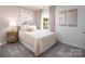 Charming bedroom with soft hues, decorative pillows, and a bright window at 414 Janie Nw Cir, Newton, NC 28658