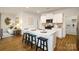 Spacious kitchen island with bar seating, stainless appliances, and hardwood floors at 414 Janie Nw Cir, Newton, NC 28658