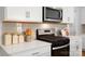 Modern kitchen with white cabinets, stainless steel appliances, and a stylish backsplash at 414 Janie Nw Cir, Newton, NC 28658