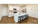 Bright kitchen featuring an island with seating, white cabinetry and stainless appliances at 414 Janie Nw Cir, Newton, NC 28658