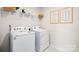 Modern laundry room features white appliances, wire shelving, and framed laundry guide wall decor at 414 Janie Nw Cir, Newton, NC 28658