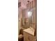 Charming bathroom with a toilet, sink, hanging mirror, and an ornate hanging light fixture at 425 Roselawn Pl, Charlotte, NC 28211