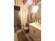 Compact bathroom with tile flooring, patterned wallpaper, shower, and a pedestal sink at 425 Roselawn Pl, Charlotte, NC 28211