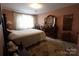 Comfortable bedroom features a dresser, plush carpet, and a cozy bed, creating a serene and welcoming atmosphere at 425 Roselawn Pl, Charlotte, NC 28211
