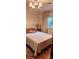 Comfortable bedroom with neutral colors, a chandelier, natural light, and calming ambiance at 425 Roselawn Pl, Charlotte, NC 28211
