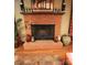 Brick fireplace with rustic decor and wood flooring, creating a warm and inviting focal point at 425 Roselawn Pl, Charlotte, NC 28211