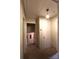 Hallway with neutral carpet and doors, provides access to rooms, with a light fixture offering brightness at 425 Roselawn Pl, Charlotte, NC 28211